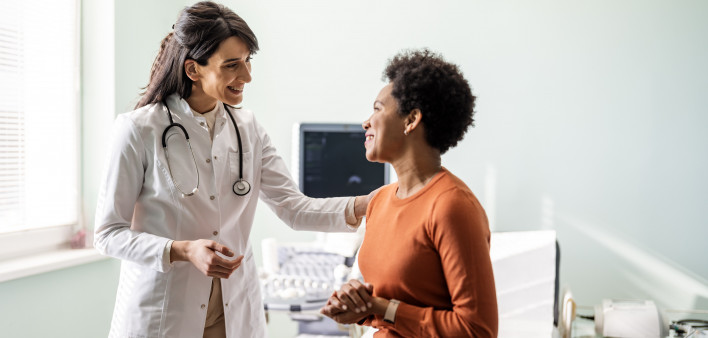 Female medical practitioner reassuring a patient