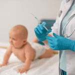 Doctor in nitrile gloves preparing to administer an injection