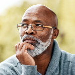 senior man outdoors thinking