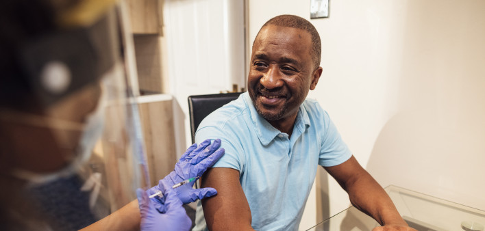 black man getting coronavirus vaccine