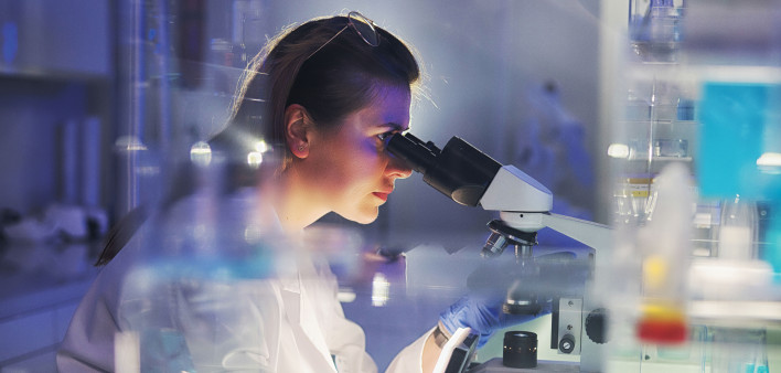 woman researcher in lab microscope