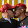 Two men participate in MPact’s Besoton Sidoso Internacional (International HIV Kiss-In) near the U.S.-Mexico border on November 30, 2025.