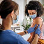 Nurse giving vaccine to patient