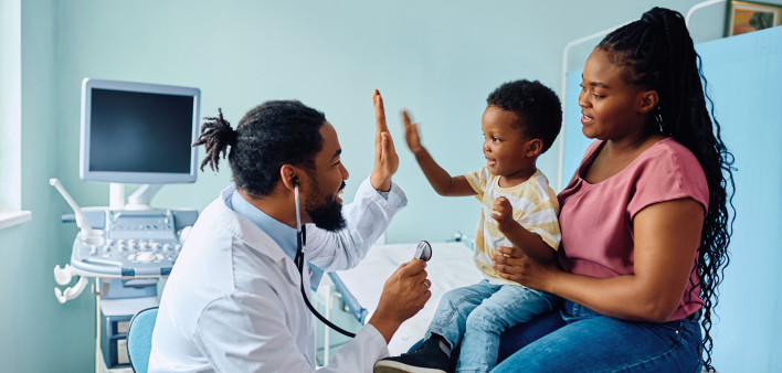 Black doctor and black mother and son in office