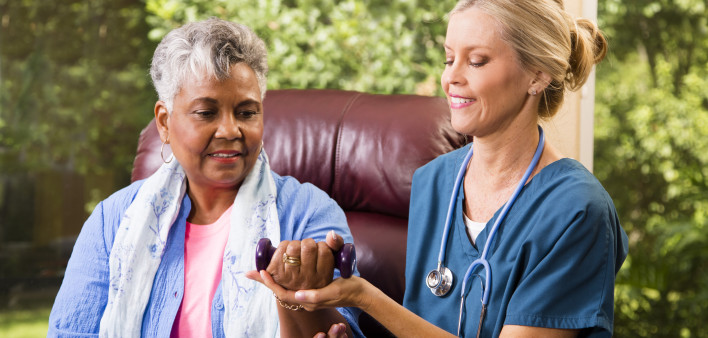 Senior adult patient with home healthcare nurse. Physical therapy. small weight
