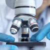 Scientist using microscope in laboratory.