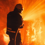 Professional Firefighter Extinguishing Large, High-Priority Part of the Forest Fire.