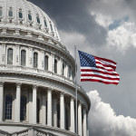 American flag waving with the Capitol Hill in the background