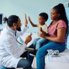 Black doctor and black mother and son in office
