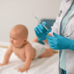 Doctor in nitrile gloves preparing to administer an injection