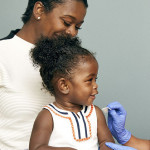 little girl and mother vaccine