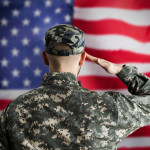 Military US Soldier Saluting Flag. Army Veteran