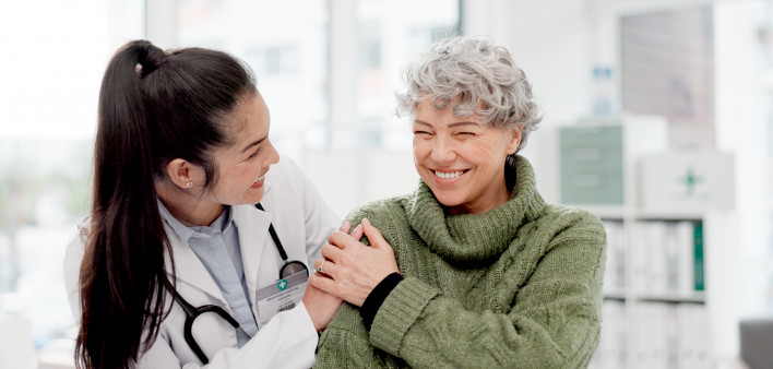 Happy, care and face of a doctor with a woman for medical trust, healthcare