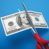 scissors cutting 100 dollar bill