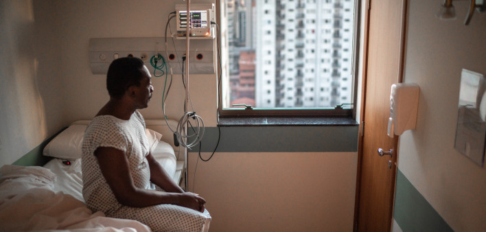 black patient in the hospital sitting in bed