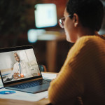 Multiethnic Latina Manager is Making Video Call to His Doctor on Laptop