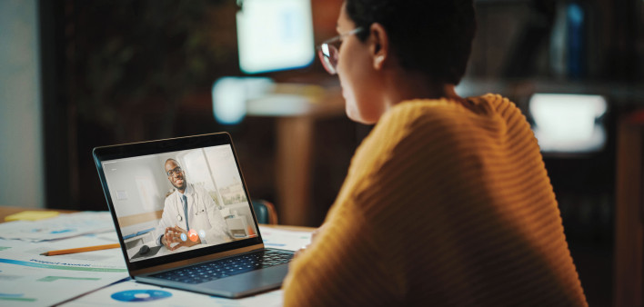 Multiethnic Latina Manager is Making Video Call to His Doctor on Laptop