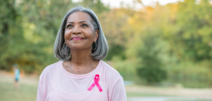 Beautiful senior woman smiles while walking for breast cancer awareness