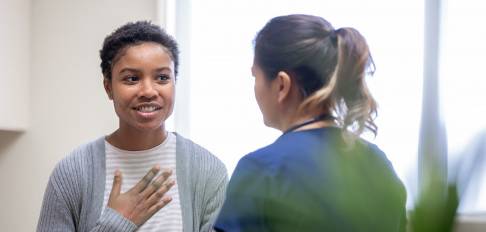 Nurse explaining good news to female patient