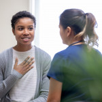 Nurse explaining good news to female patient