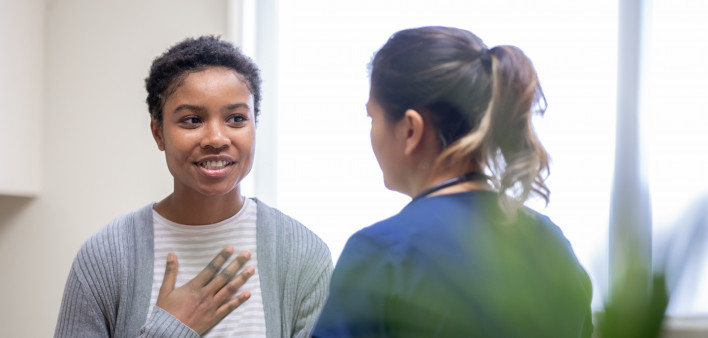 Nurse explaining good news to female patient