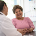 Older Woman talking with the Doctor laughing