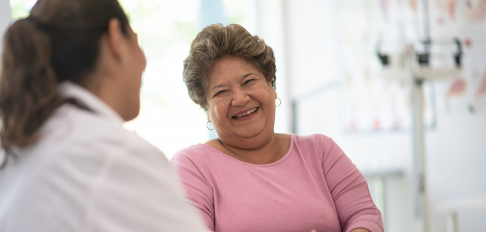 Older Woman talking with the Doctor laughing