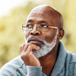 senior man outdoors thinking