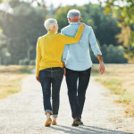 elderly couple walking in the park