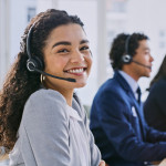 Call center woman, happy and portrait at help desk, job and staff group with computer, advice and office.