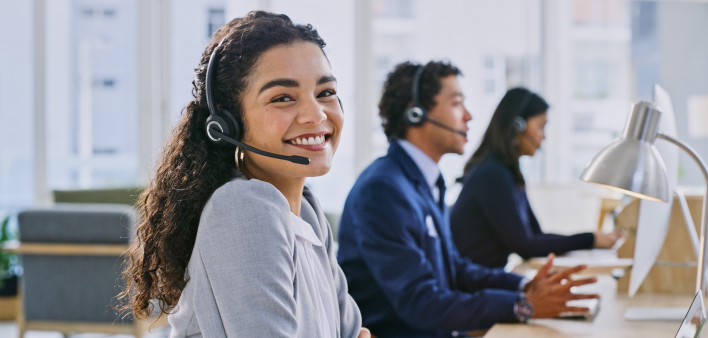 Call center woman, happy and portrait at help desk, job and staff group with computer, advice and office.