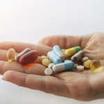 hand holding vitimins and supplements