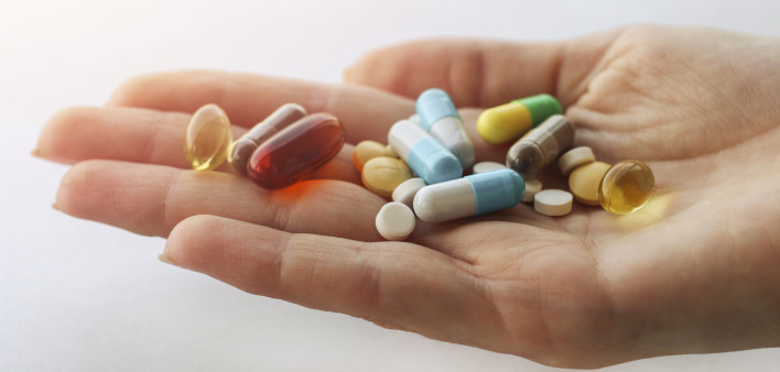 hand holding vitimins and supplements