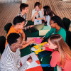 group of young people socializing around a table