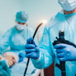 Endoscopy at the hospital. Doctor holding endoscope before gastroscopy stock photo Colonoscopy, Endoscope, Esophagus, Doctor, Patient