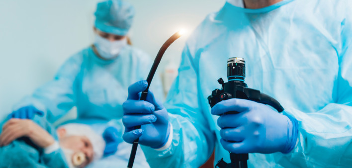 Endoscopy at the hospital. Doctor holding endoscope before gastroscopy stock photo Colonoscopy, Endoscope, Esophagus, Doctor, Patient