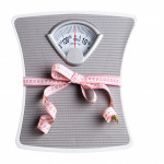 scale squeezed by tape measure weight loss