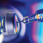needle going into vial vaccine