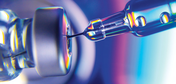 needle going into vial vaccine