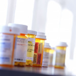Several prescription medication bottles sit on a table.
