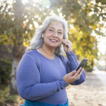 senior woman listening to music on phone
