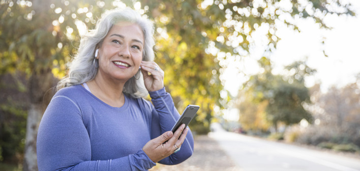 senior woman listening to music on phone