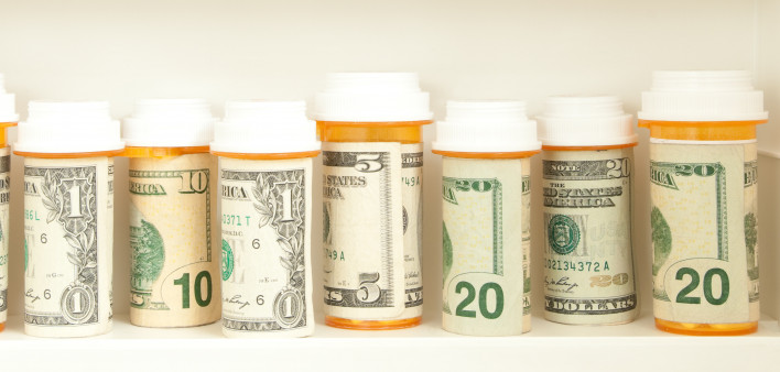 pill bottles with money as labels cost of healthcare