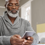 Smart apps make for smart budgeting senior black man with phone