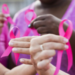 Multi-ethnic women with breast cancer awareness ribbons