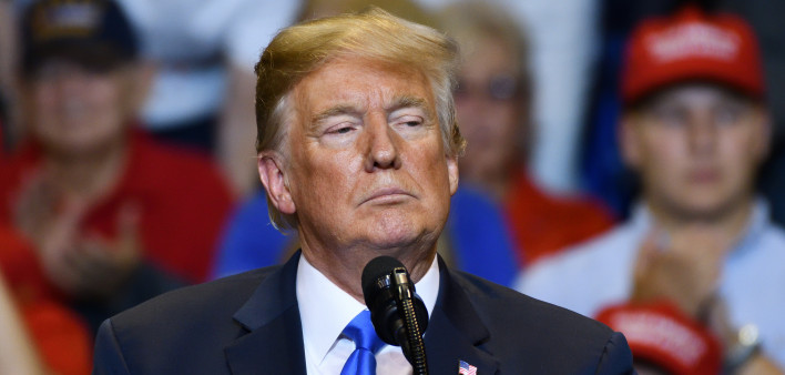 President Donald Trump with a serious look as he delivers a speech at a campaign rally held at the Mohegan Sun Arena.
