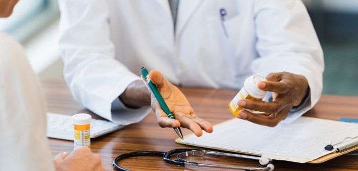 Female doctor discusses medication with patient