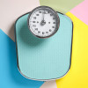 One bathroom scale on color background, top view