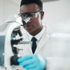 researcher looking into microscope