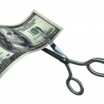 Scissors Cutting One Hundred Dollar Bill